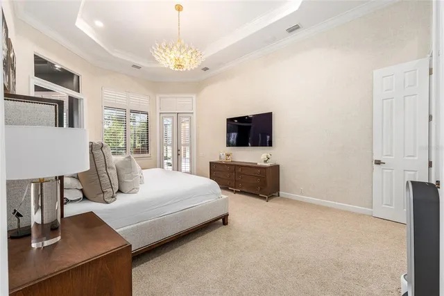 a spacious bedroom with a large bed and a dresser