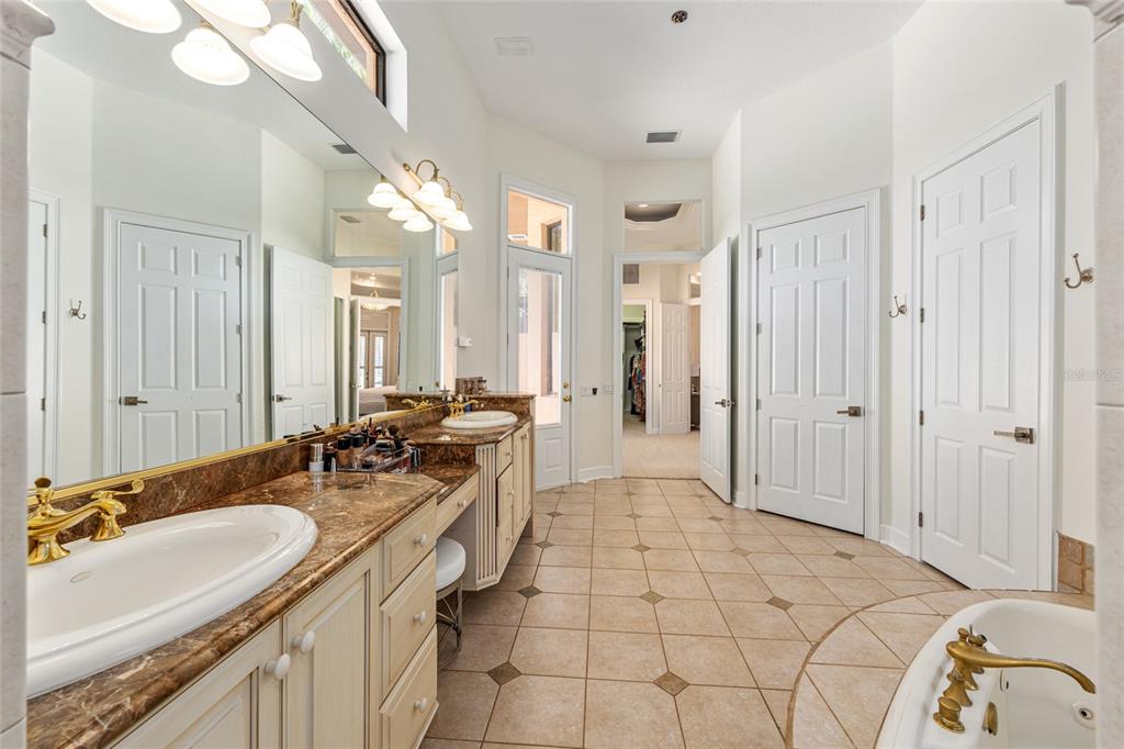 708 Southeast 44th Road Ocala, FL 34480 - Photo 42 of 76 a spacious bathroom with a double vanity sink a mirror and a shower