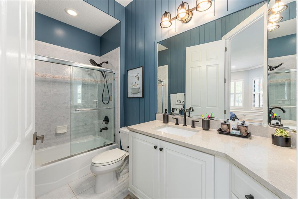 708 Southeast 44th Road Ocala, FL 34480 - Photo 46 of 76 a bathroom with a double vanity sink toilet mirror and shower