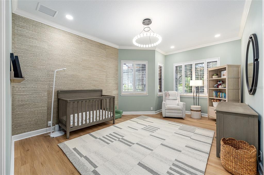 708 Southeast 44th Road Ocala, FL 34480 - Photo 48 of 76 a bedroom with a bed and wooden floor