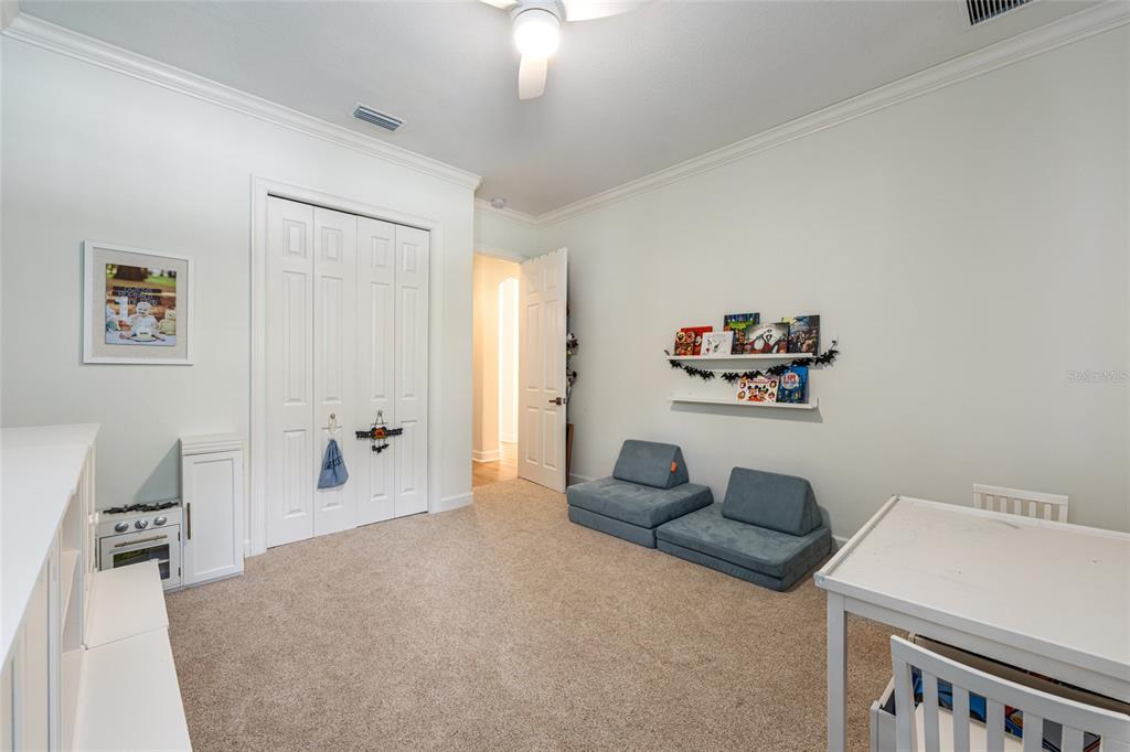 708 Southeast 44th Road Ocala, FL 34480 - Photo 52 of 76 a bedroom with furniture and a chandelier