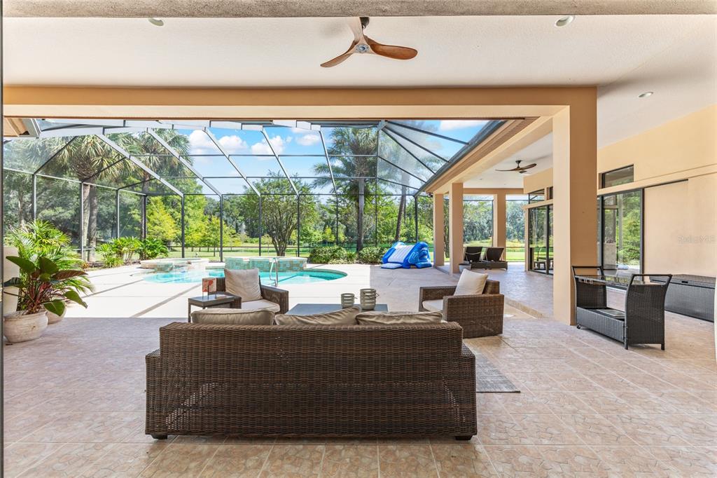 708 Southeast 44th Road Ocala, FL 34480 - Photo 53 of 76 a living room with couches and a large window with garden view