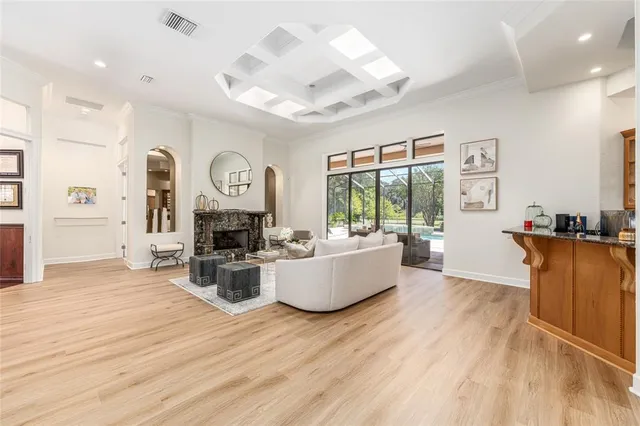 a living room with furniture and wooden floors