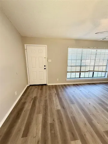 a view of an empty room and wooden floor