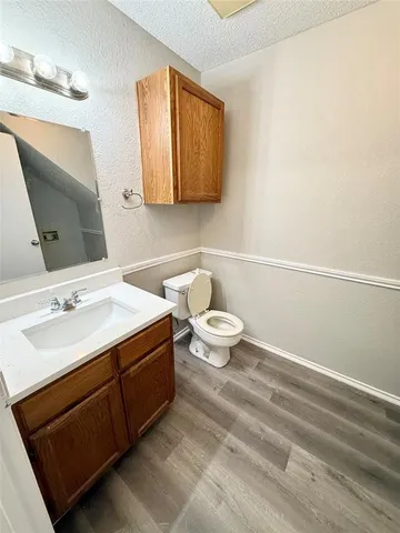 a bathroom with a sink a toilet and mirror