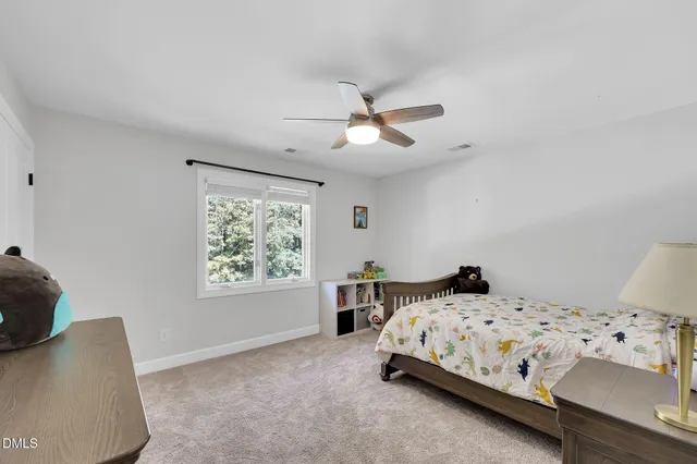 a view of a patio with a table and chairs and wooden fence