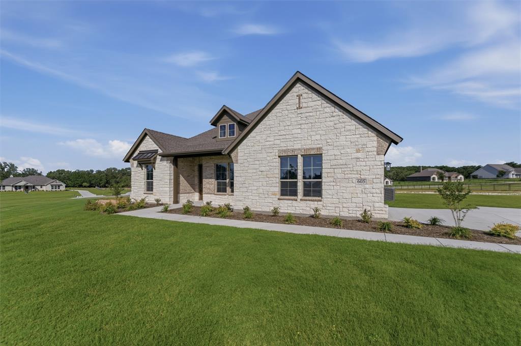 605 Tay Tay Way Springtown, TX 76082 - Photo 2 of 31 Stone and brick exterior featuring a multi-gabled roofline and dark framed windows