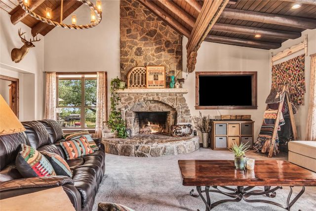 a kitchen with a sink and chairs
