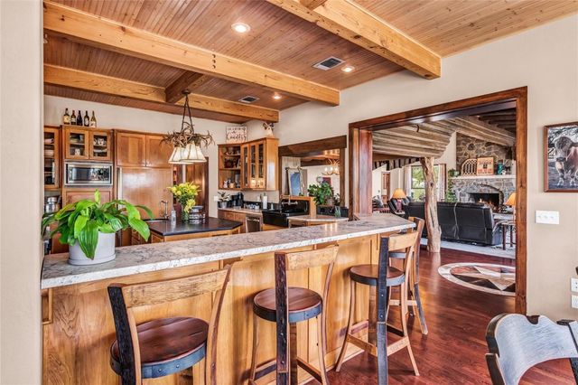a bathroom with a granite countertop sink and a large mirror