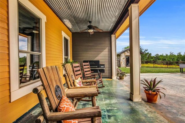 a view of a house with backyard porch and sitting area