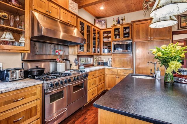 a kitchen with stainless steel appliances granite countertop a sink and cabinets