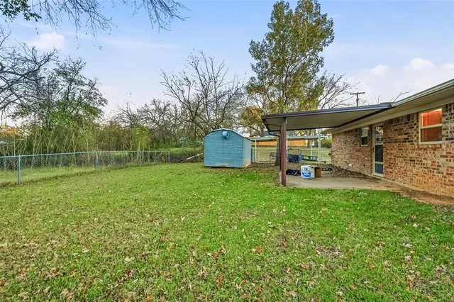 a backyard of a house with table and chairs