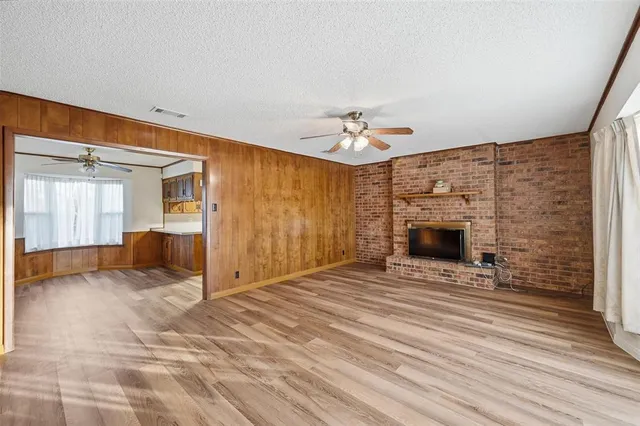 a view of an empty room with a fireplace