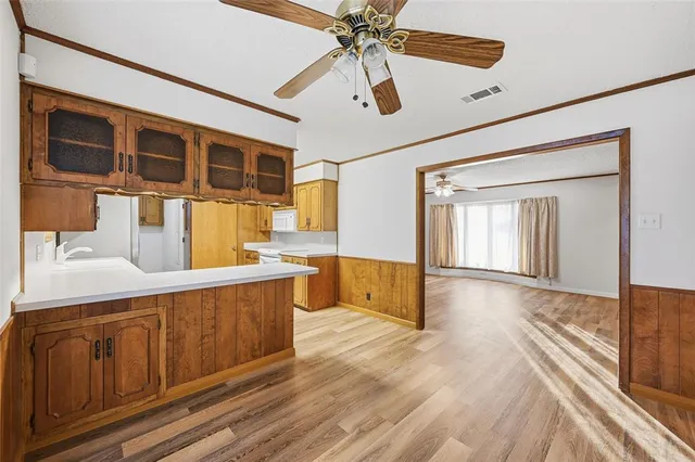 a view of a kitchen with a sink and cabinets