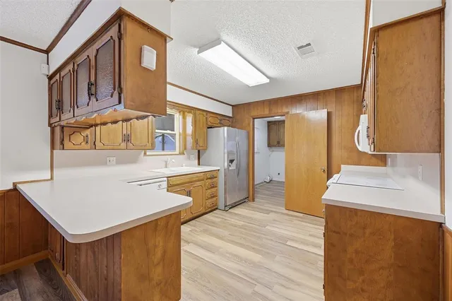 a kitchen with a sink a stove and a refrigerator
