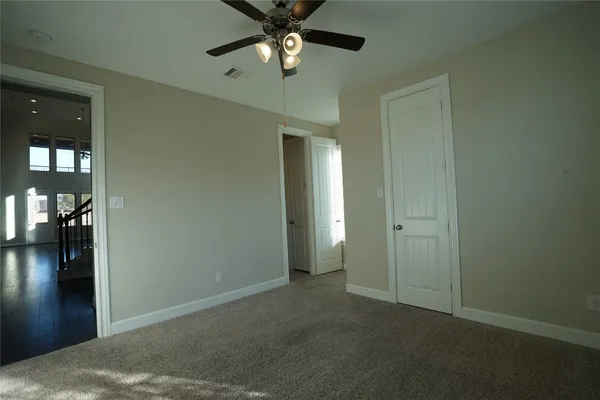 wooden floor in an empty room and a bathroom