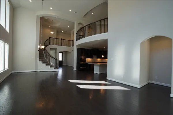 a view of a hallway with wooden floor and a cabinet