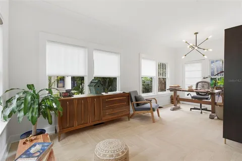 a kitchen with a sink a stove cabinets and wooden floor