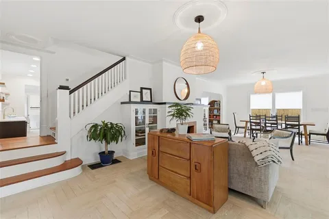 a living room with furniture and view of kitchen