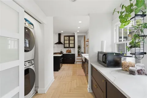 a bedroom with a bed and a wooden floor
