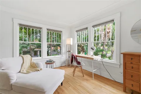 a living room with furniture and a floor to ceiling window