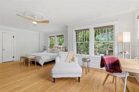 a living room with furniture kitchen view and a large window