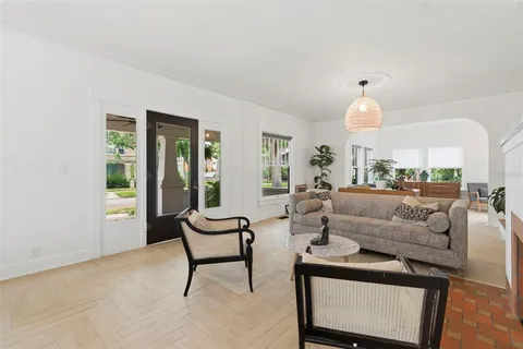 a view of living room kitchen with furniture and a chandelier