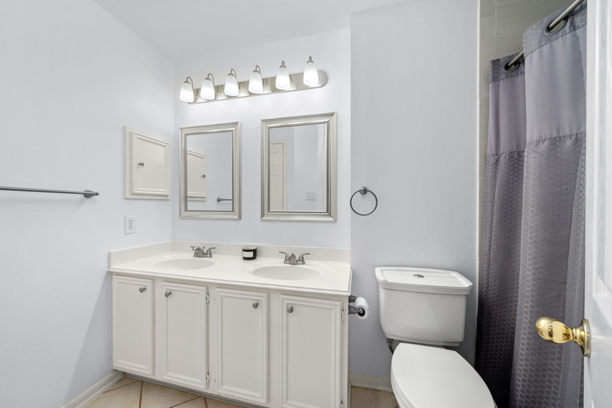 9715 Therrell Drive Houston, TX 77064 - Photo 26 of 33 This bathroom features a double vanity with ample storage, and modern lighting. The space is bright and functional, perfect for daily use.