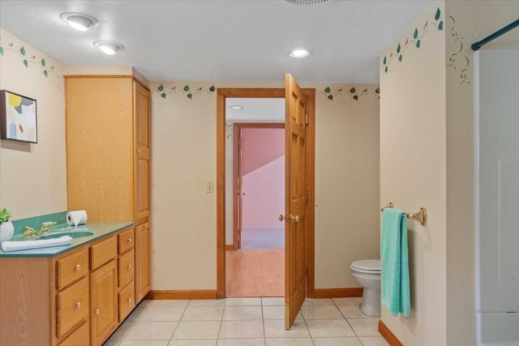30 Tobin Road Leicester, MA 01611 - Photo 22 of 33 a bathroom with a granite countertop sink a toilet and shower