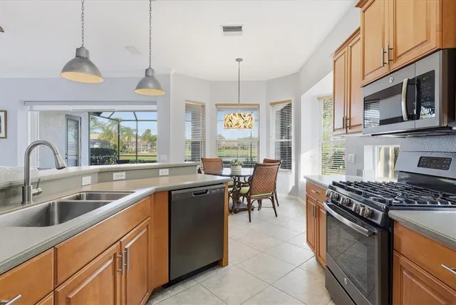 a dining room with furniture a flat screen tv and large windows