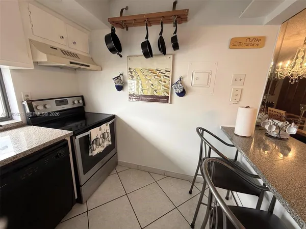 a kitchen with a stove and a refrigerator