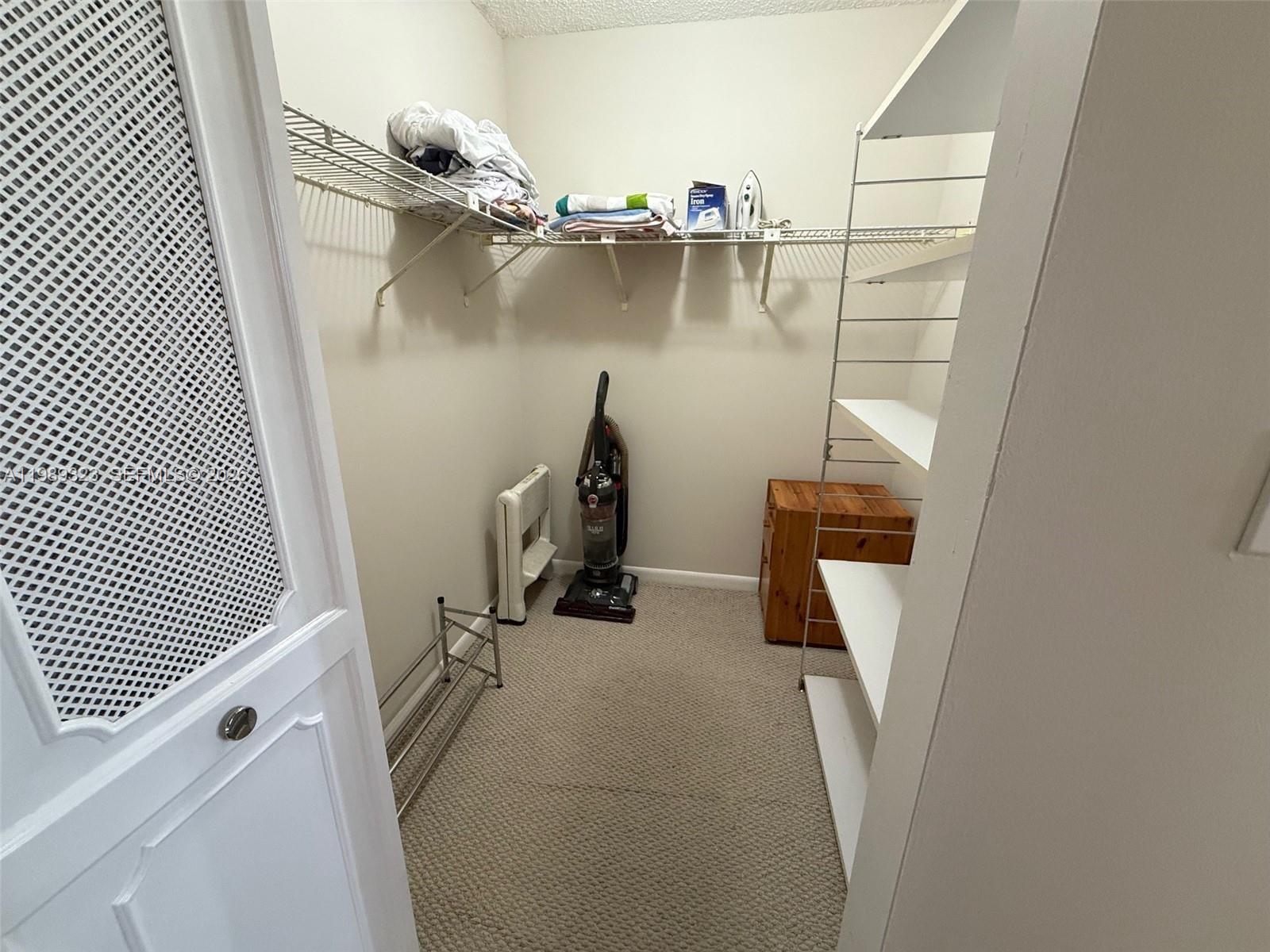 17011 North Bay Road, Unit 1007 Sunny Isles Beach, FL 33160 - Photo 16 of 28 a view of a closet with storage and utility room