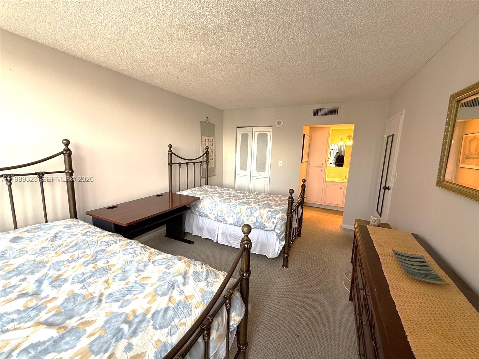17011 North Bay Road, Unit 1007 Sunny Isles Beach, FL 33160 - Photo 17 of 28 a bedroom with a bed and wooden floor
