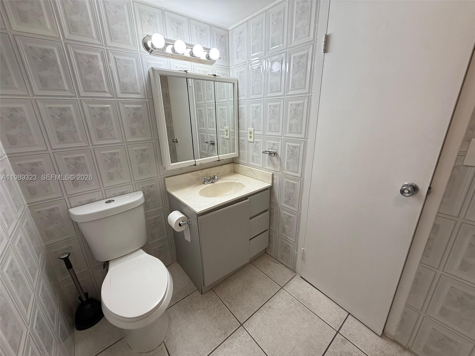 17011 North Bay Road, Unit 1007 Sunny Isles Beach, FL 33160 - Photo 19 of 28 a bathroom with a sink a toilet and shower