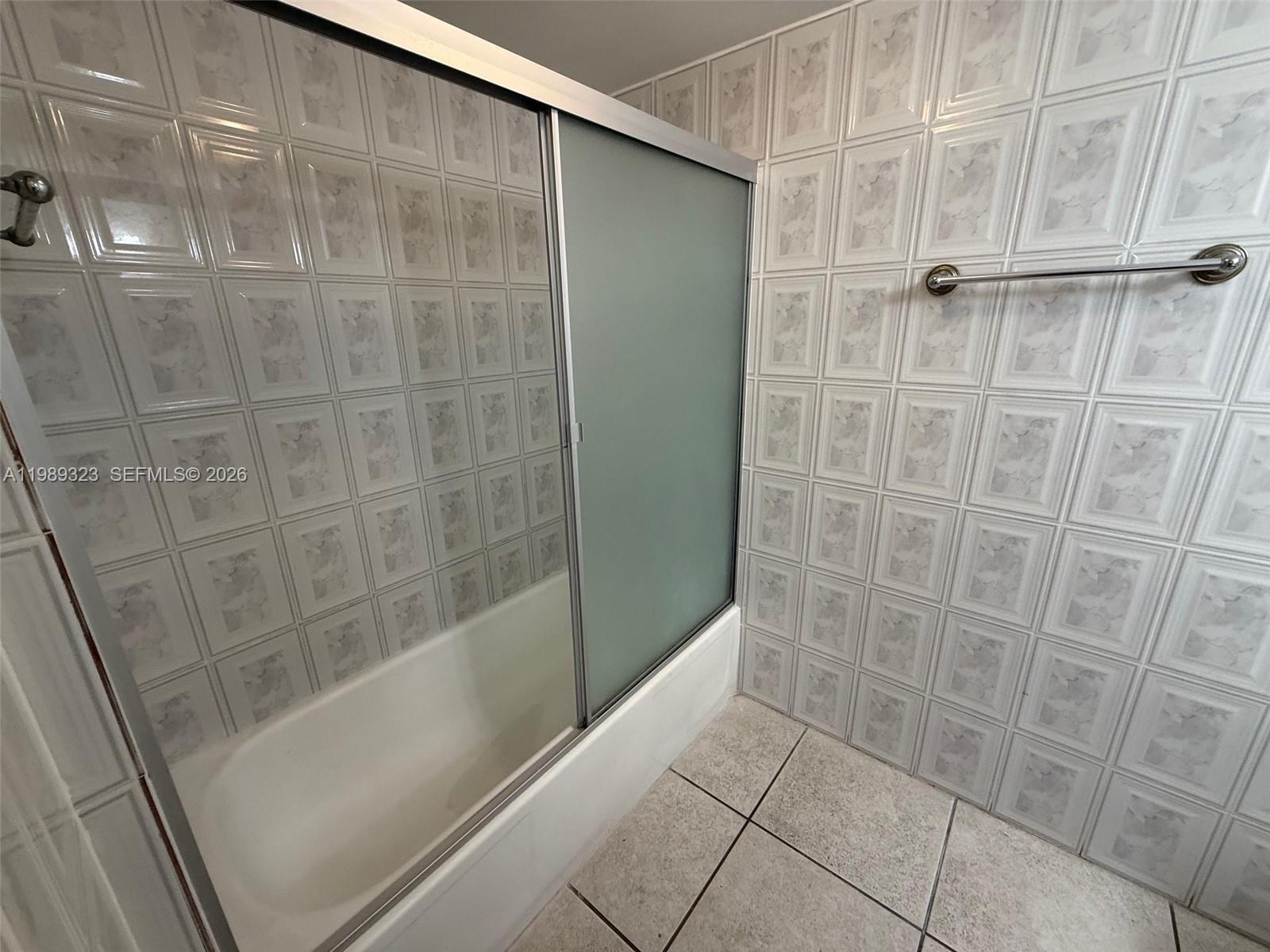 17011 North Bay Road, Unit 1007 Sunny Isles Beach, FL 33160 - Photo 20 of 28 a bathroom with a shower and a glass door