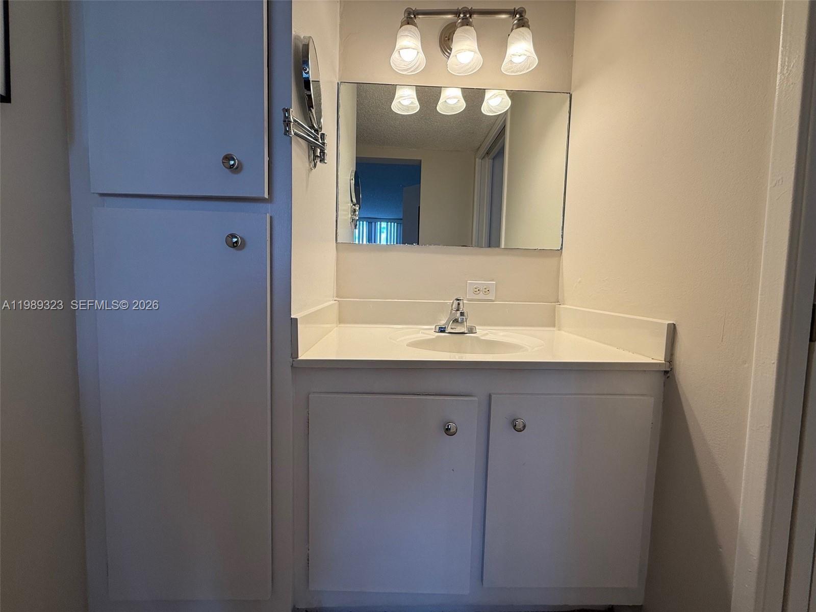 17011 North Bay Road, Unit 1007 Sunny Isles Beach, FL 33160 - Photo 22 of 28 a bathroom with a sink and a mirror