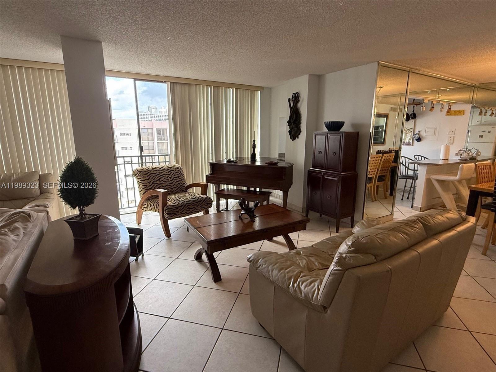 17011 North Bay Road, Unit 1007 Sunny Isles Beach, FL 33160 - Photo 7 of 28 a living room with furniture and a window