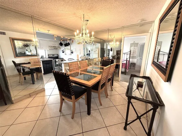 a view of a dining room with furniture and a chandelier