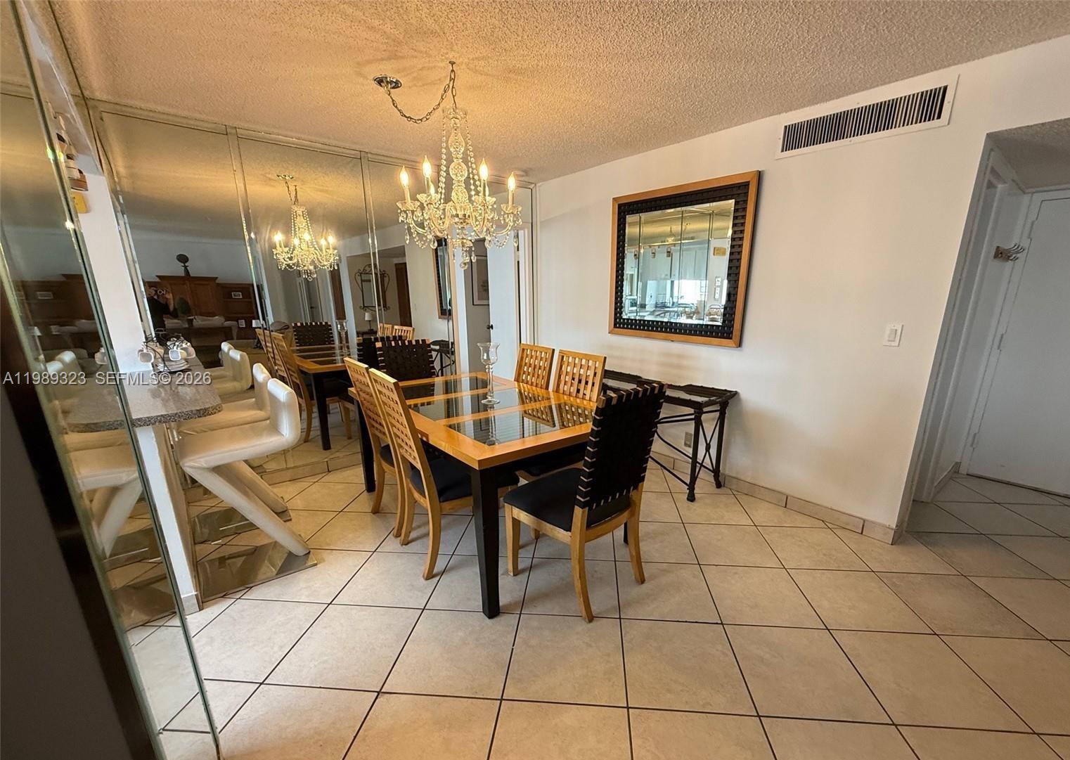 17011 North Bay Road, Unit 1007 Sunny Isles Beach, FL 33160 - Photo 10 of 28 a view of a dining room with furniture
