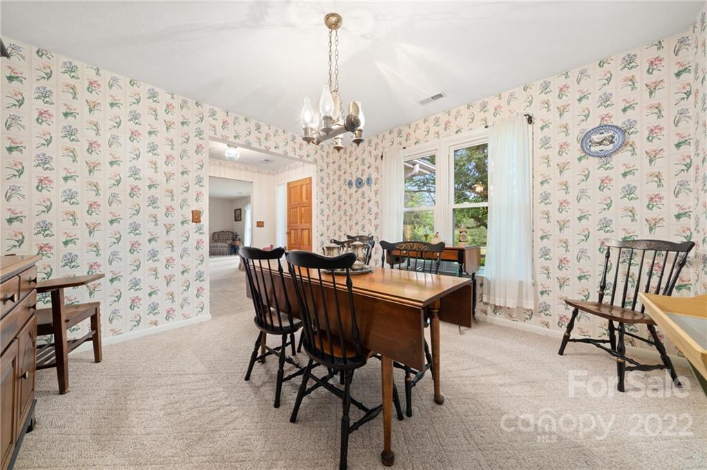 2480 Ridge Road Hendersonville, NC 28792 - Photo 13 of 48 a view of a dining room with furniture and a chandelier