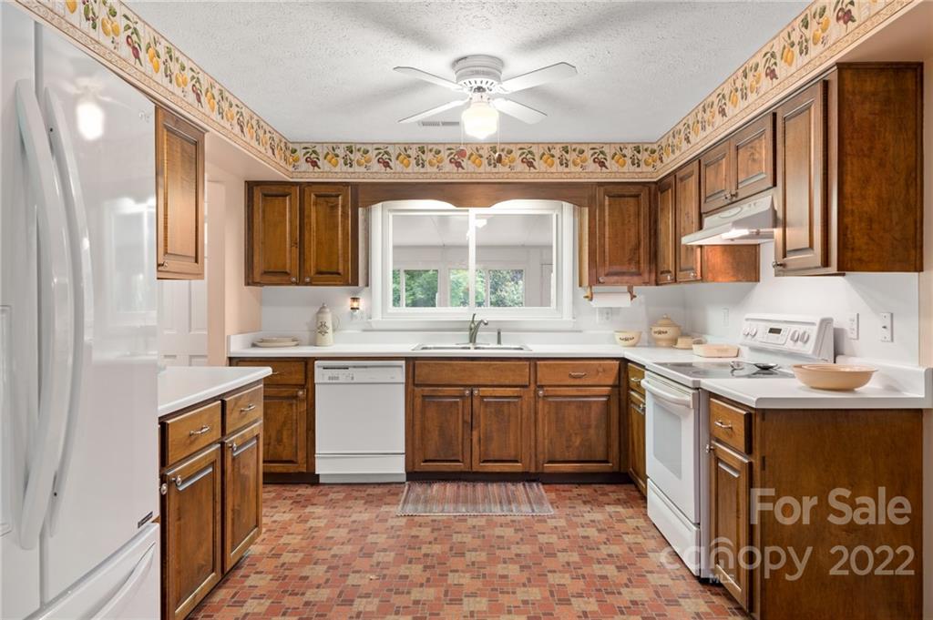 2480 Ridge Road Hendersonville, NC 28792 - Photo 15 of 48 a large kitchen with stainless steel appliances granite countertop a sink and cabinets