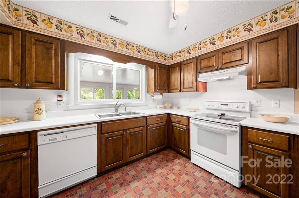 2480 Ridge Road Hendersonville, NC 28792 - Photo 17 of 48 a kitchen with a sink cabinets appliances and a window