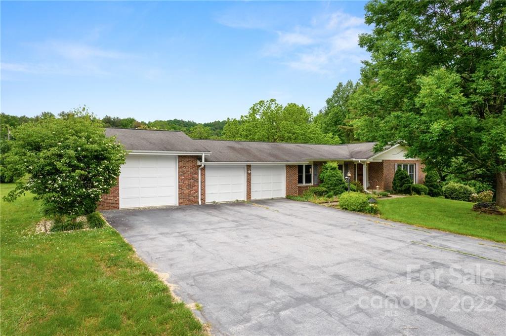 2480 Ridge Road Hendersonville, NC 28792 - Photo 2 of 48 a front view of a house with a yard and a garage
