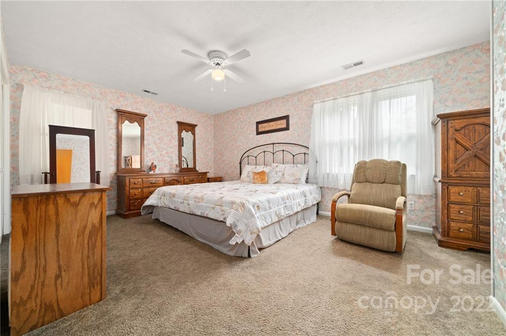 2480 Ridge Road Hendersonville, NC 28792 - Photo 27 of 48 a bedroom with a bed couches and a window