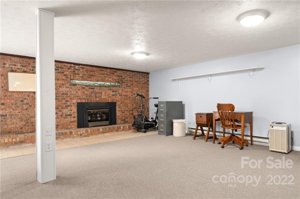 2480 Ridge Road Hendersonville, NC 28792 - Photo 34 of 48 a view of a livingroom with a fireplace and a workspace