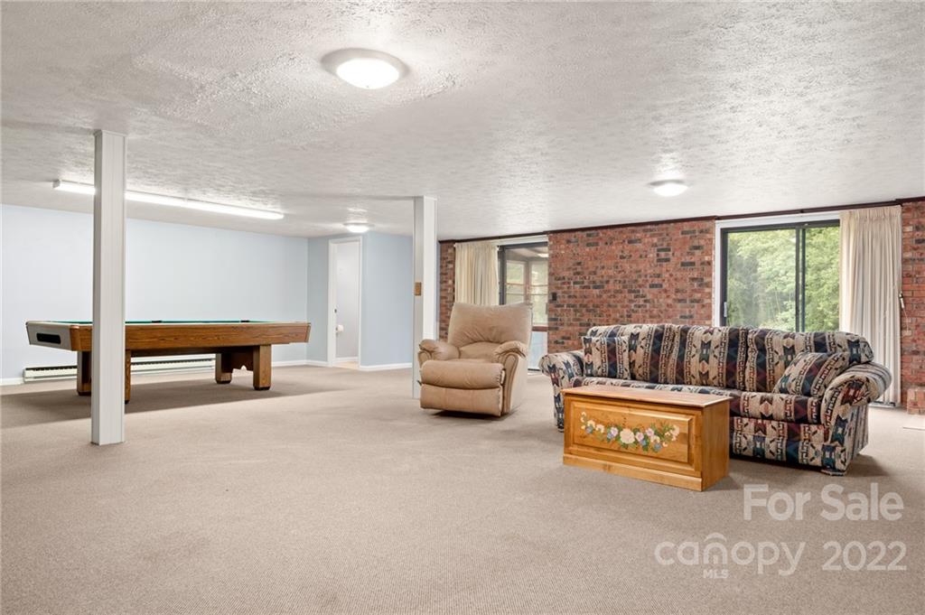 2480 Ridge Road Hendersonville, NC 28792 - Photo 35 of 48 a living room with furniture and a floor to ceiling window