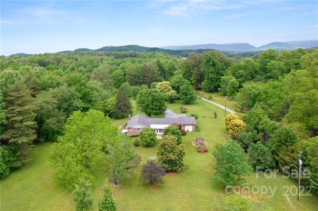 2480 Ridge Road Hendersonville, NC 28792 - Photo 42 of 48 a view of a lake with a house in a yard