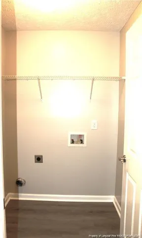 an empty room with a chandelier fan and windows