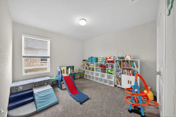 a bedroom with furniture and a potted plant