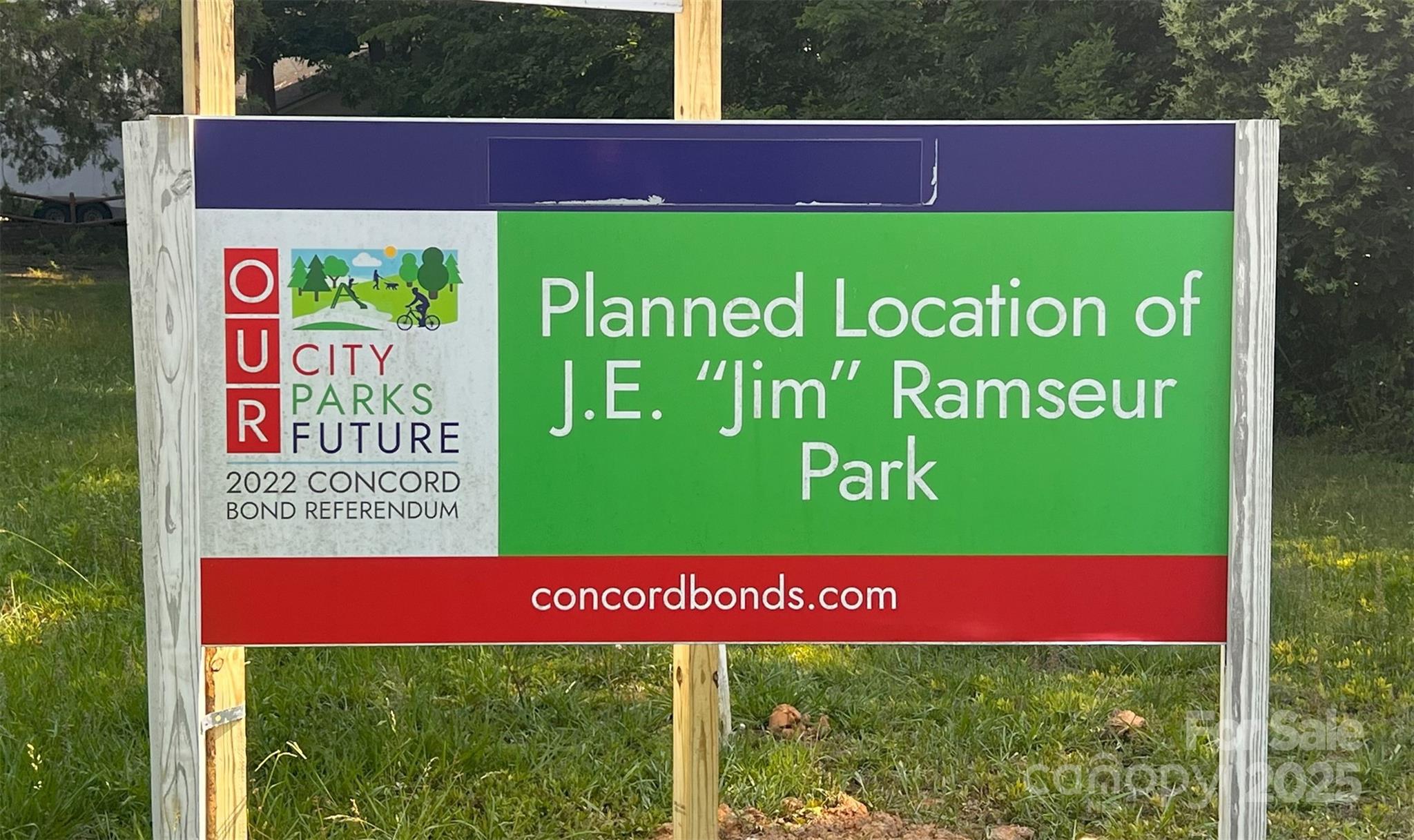1243 Cox Mill Road Concord, NC 28027 - Photo 6 of 6 a sign that is on a wooden bench in front of a building